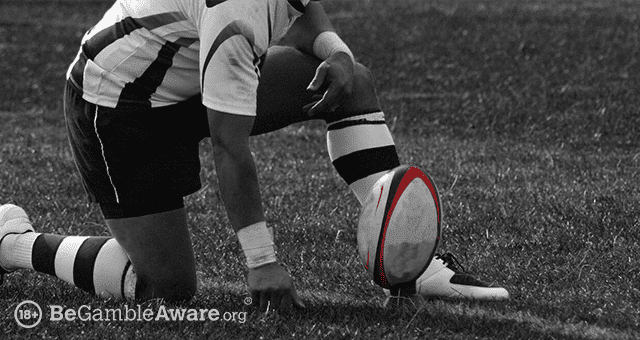 a rugby player about to perform a place kick