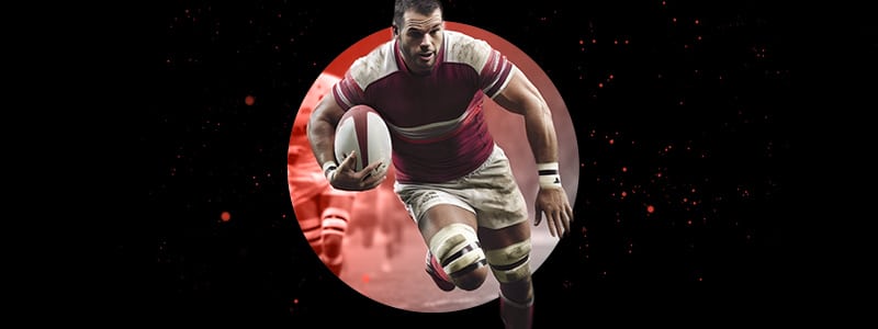 a rugby player holding the ball and running