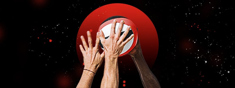 volleyball players' hands trying to block the ball