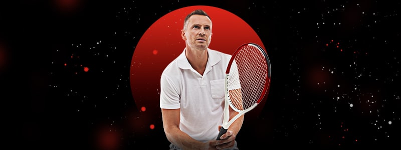 a male tennis player holding its racquet and preparing to hit