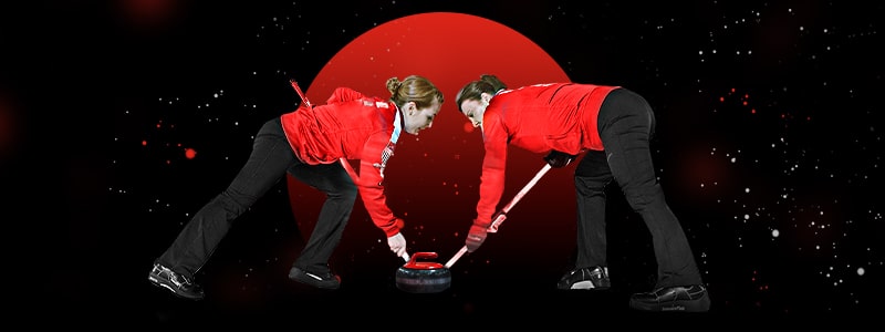 two curling female players during a competition