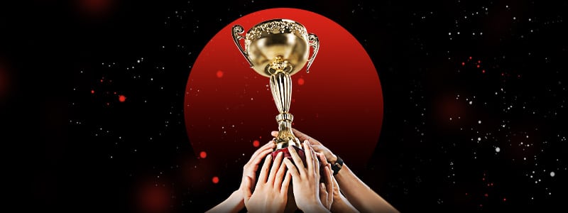 netball players' hand holding trophy from a competition